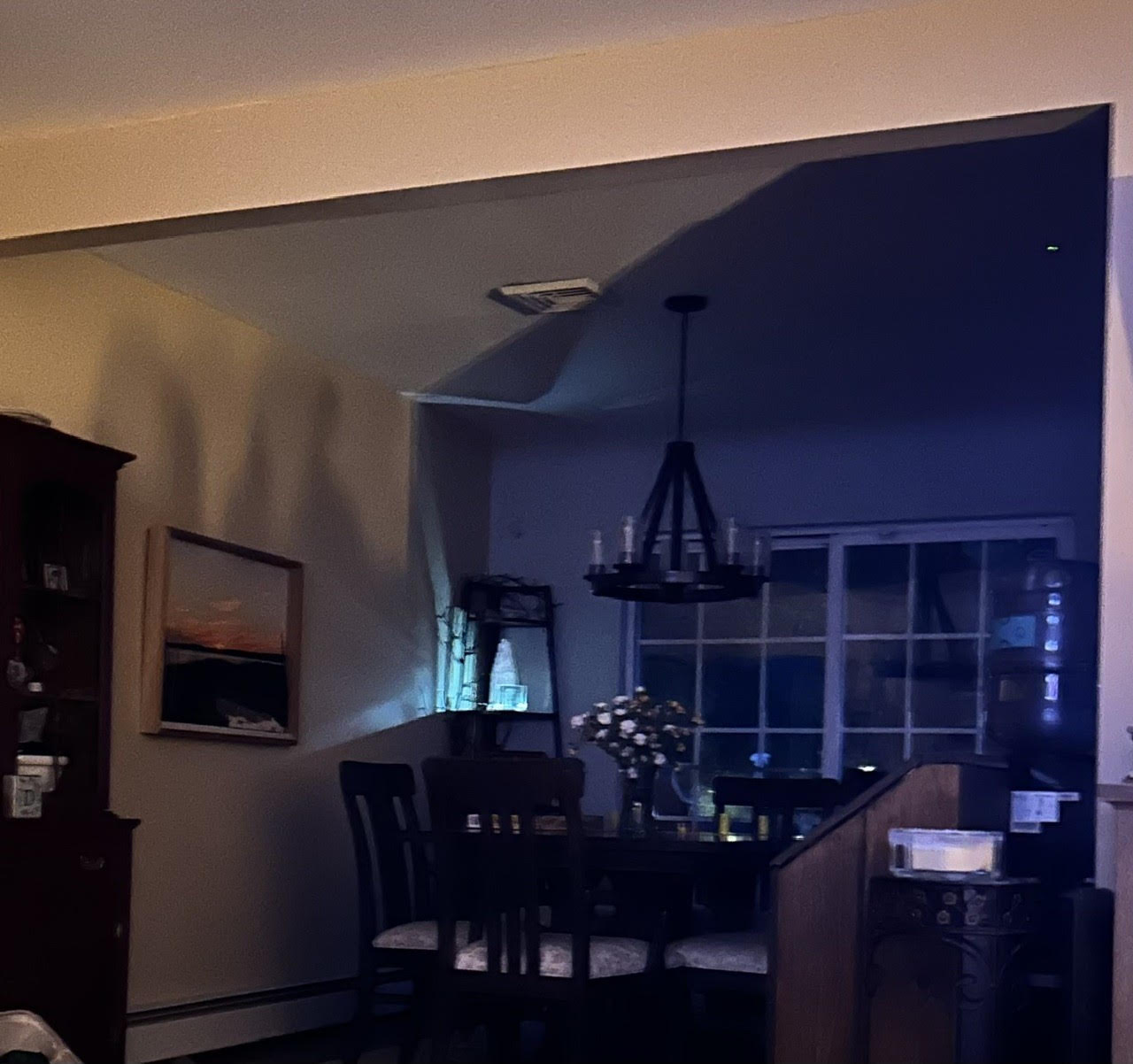 The dining room at night, lit by two small spotlights illuminating Bo's glass portrait