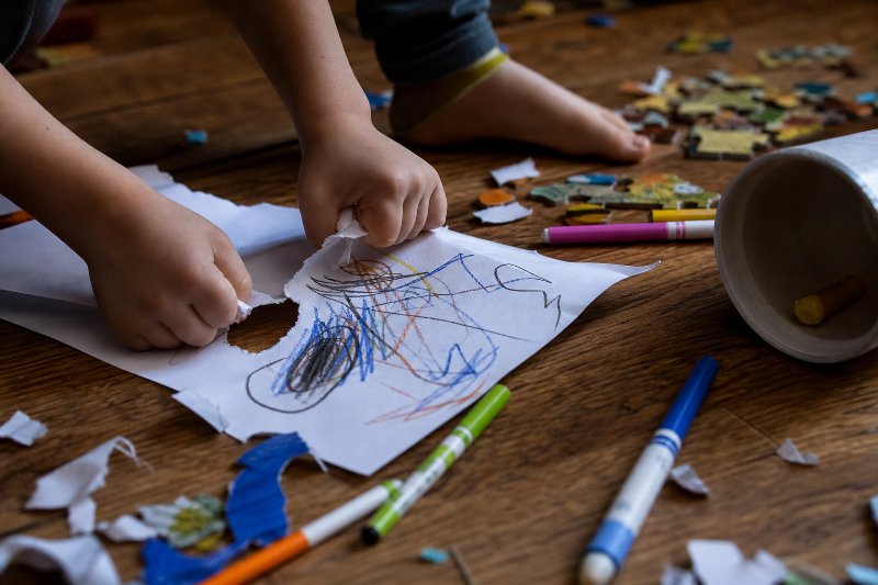 Signs your child struggles with emotional regulation shown through scattered toys and tense hands