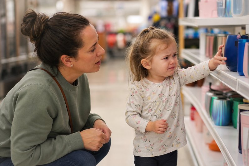 Helping Children Handle Disappointment in a store aisle with a child upset about not getting the blue cup