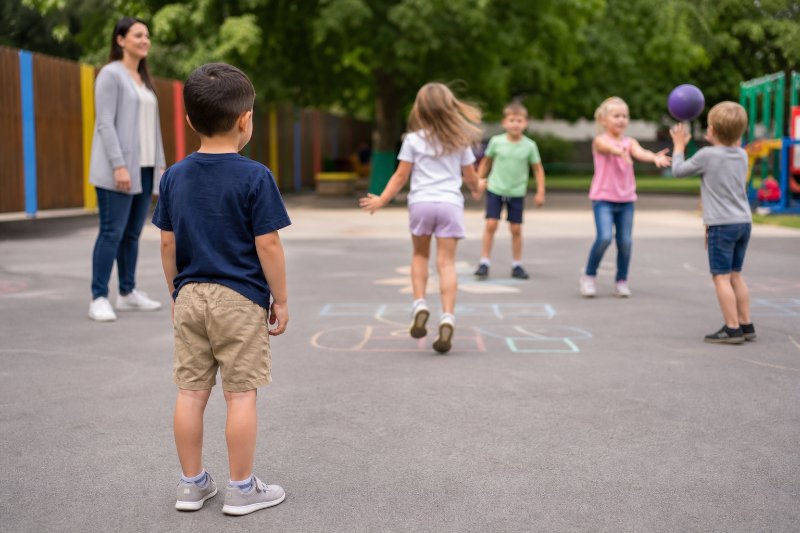 Helping kids make friends with a child hesitating near a playground group